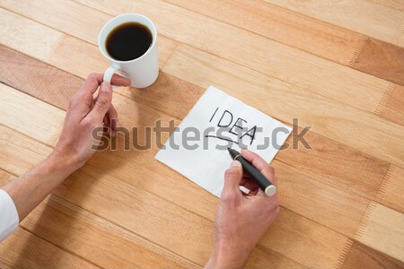 Woman holding a document and using mobile phone Stock photo © wavebreak_media