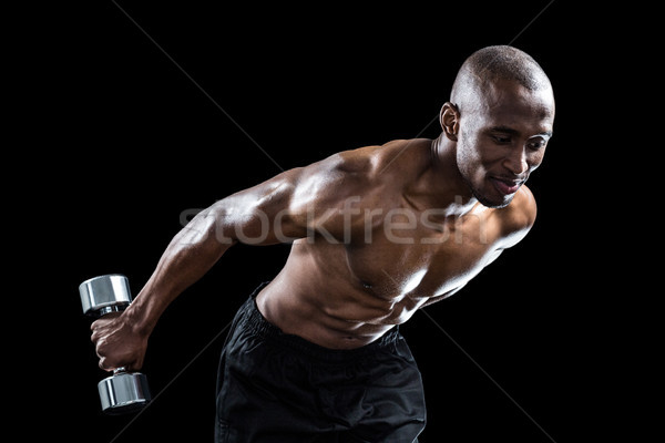 Muscular man bending while exercising Stock photo © wavebreak_media