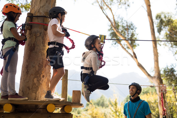 Kids enjoying zip line adventure on sunny day Stock photo © wavebreak_media