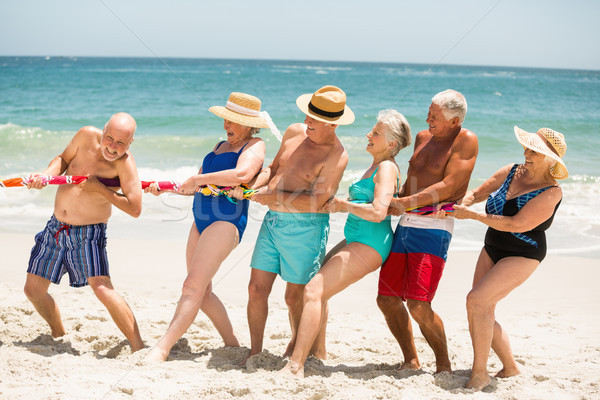 Seniors playing tug of war at the beach Stock photo © wavebreak_media