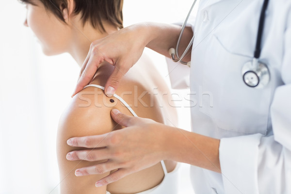 Midsection of doctor examining woman Stock photo © wavebreak_media