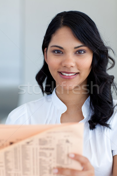 Stock photo: Beautiful businesswoman reading a newspaper