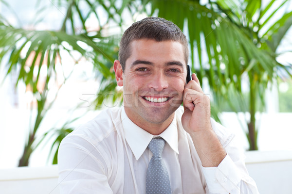 Stock photo: Friendly businessman on phone sitting on a couch