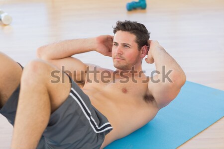 Youn man relaxing in bed Stock photo © wavebreak_media