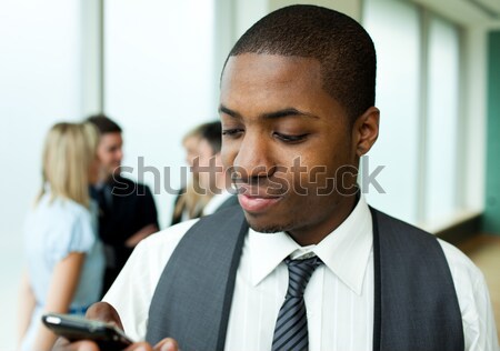 Stock photo: Smiling ethnic business leader in front of team 