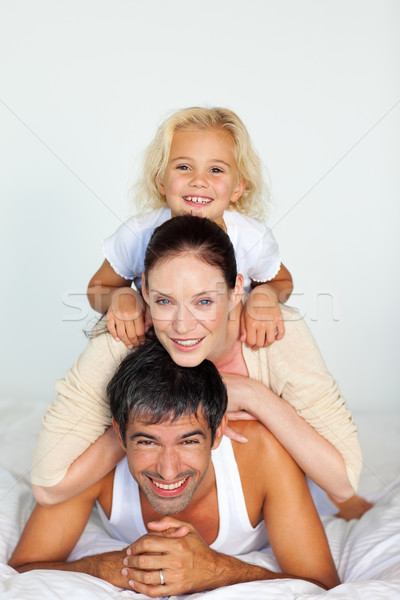 Famiglia bianco letto donna sorriso uomo Foto d'archivio © wavebreak_media