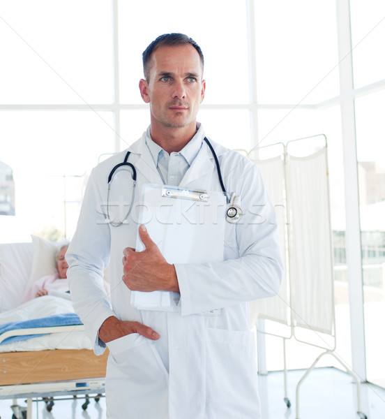 Serious doctor holding a medical clipboard  Stock photo © wavebreak_media