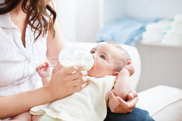 Bright mother feeding her adorable son in the kitchen at home Stock photo © wavebreak_media