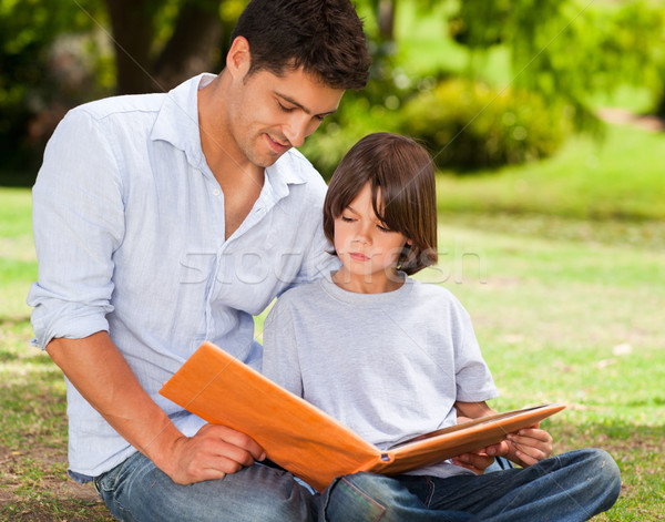 Son with his father looking at their album photo Stock photo © wavebreak_media