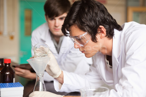 Students in chemistry making an experiment in a laboratory Stock photo © wavebreak_media