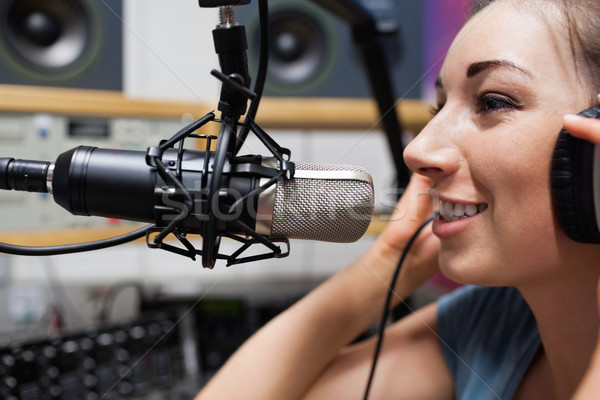Close up of a young radio host speaking through a microphone Stock photo © wavebreak_media
