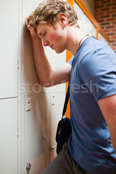 Portrait of a lonely student leaning on a locker Stock photo © wavebreak_media