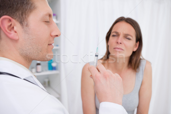 Doctor about to give an injection to patient Stock photo © wavebreak_media
