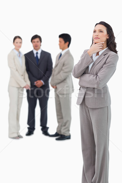 Thoughtful saleswoman with team behind her against a white background Stock photo © wavebreak_media