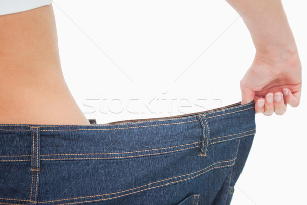 Close-up of a woman waist in a too big pants against white background Stock photo © wavebreak_media