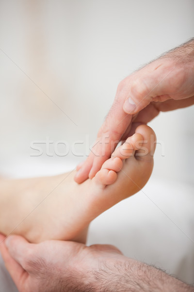 Physiotherapist offering a foot massage in a medical room Stock photo © wavebreak_media