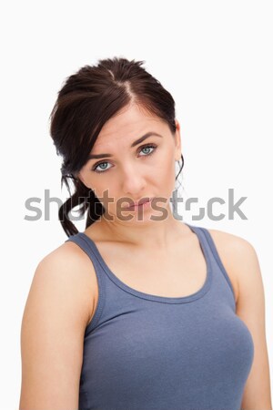Blue eyed woman pouting against white background Stock photo © wavebreak_media