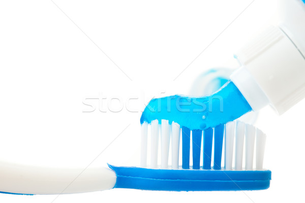 Close up of a toothpaste on a toothbrush against white background Stock photo © wavebreak_media
