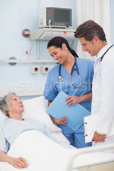 Elderly patient talking to a doctor and a nurse in hospital ward Stock photo © wavebreak_media
