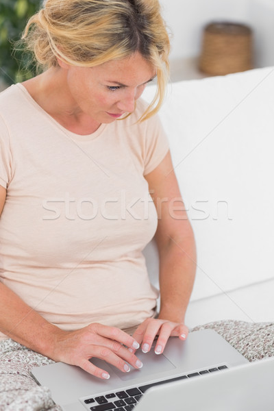 Blonde woman using her laptop Stock photo © wavebreak_media