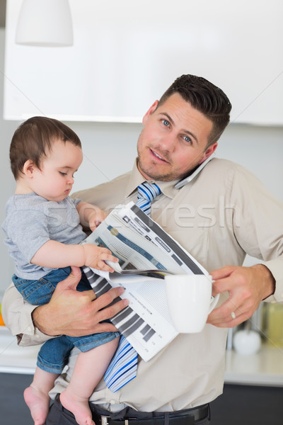 Portrait of busy father multi tasking in house Stock photo © wavebreak_media