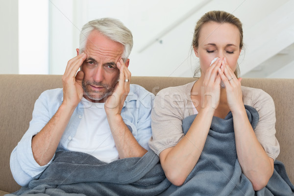 Sick couple sitting on the couch under a blanket Stock photo © wavebreak_media