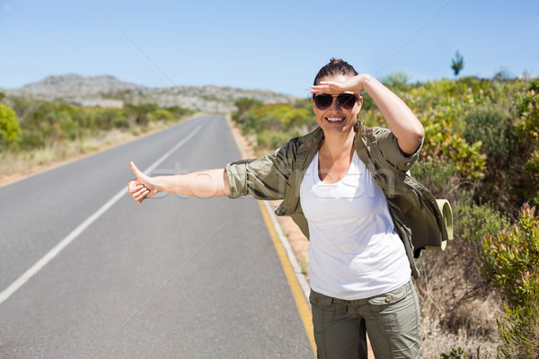 Pretty hitchhiker sticking thumb out on the road Stock photo © wavebreak_media
