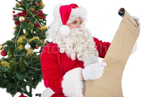 Santa with glasses reading a parchment  Stock photo © wavebreak_media