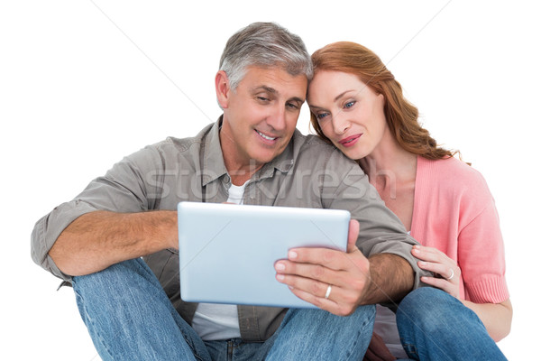 Casual couple sitting using tablet Stock photo © wavebreak_media