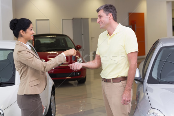 Smiling businesswoman giving car key to happy customer Stock photo © wavebreak_media