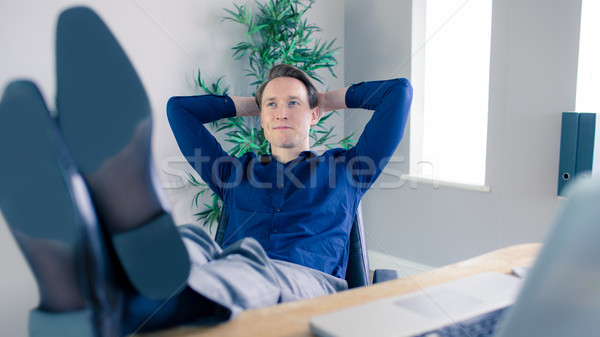 Smiling businessman relaxing in a swivel chair Stock photo © wavebreak_media