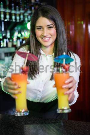 Composite image of portrait of bartender serving cocktail at bar counter Stock photo © wavebreak_media