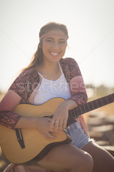 Portrait of smiling woman with guitar Stock photo © wavebreak_media