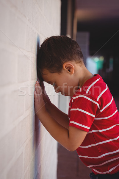 Side view of sad boy leaning on wall Stock photo © wavebreak_media