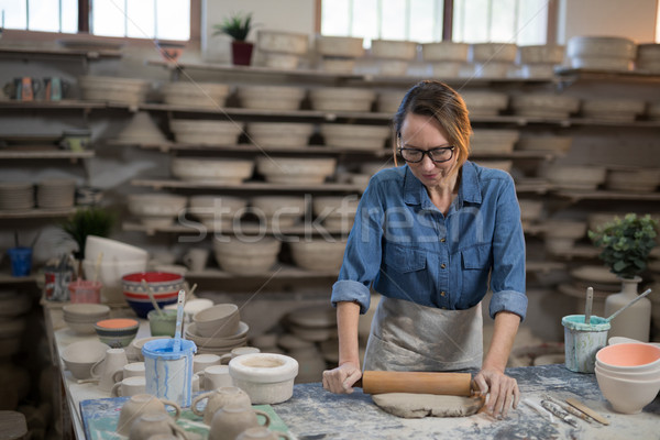 Female potter flattening the clay with rolling pin Stock photo © wavebreak_media