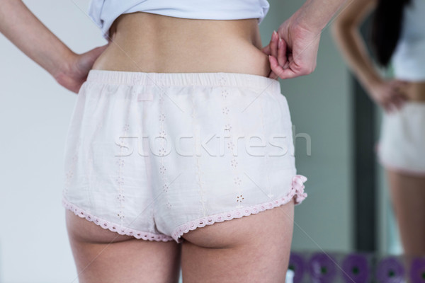 Stock photo: Standing woman pinching her hip