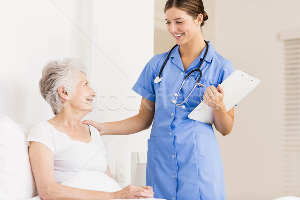 Doctor taking care of suffering senior patient  Stock photo © wavebreak_media
