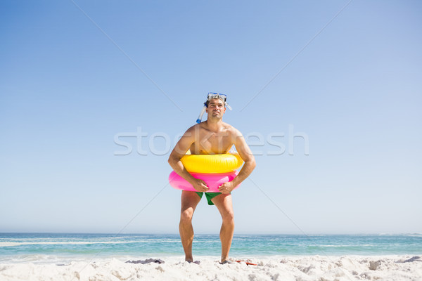 Smiling man posing with rubber ring Stock photo © wavebreak_media