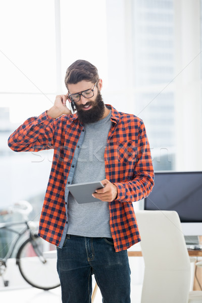 Hipster using tablet and smartphone Stock photo © wavebreak_media