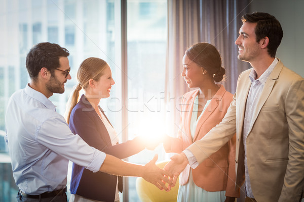 Businessmen and businesswomen shaking hands with each other Stock photo © wavebreak_media