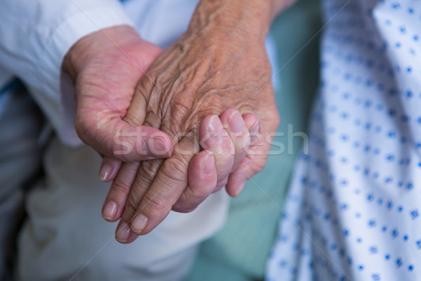 Doctor consoling senior patient in hospital Stock photo © wavebreak_media