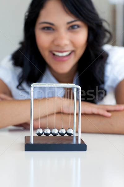 Businesswoman playing with kinetic balls Stock photo © wavebreak_media