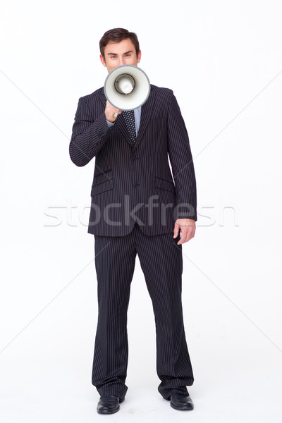 Attractive businessman shouting through a megaphone Stock photo © wavebreak_media