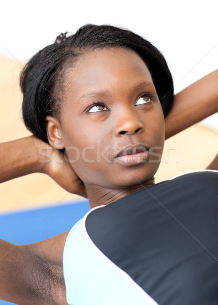 Concentrated woman in gym clothes excercising  Stock photo © wavebreak_media
