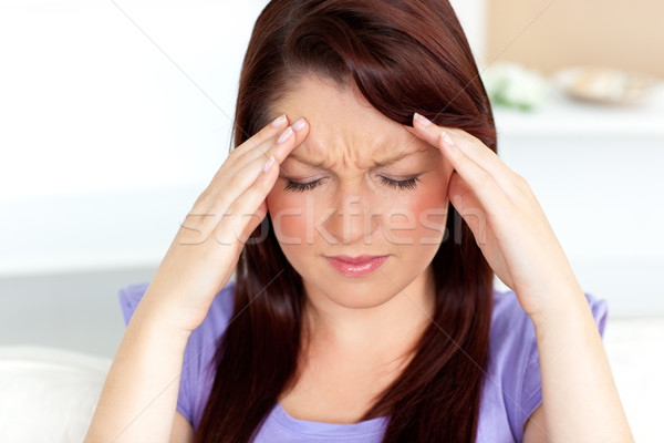 Young woman with headache at home in the living-room Stock photo © wavebreak_media