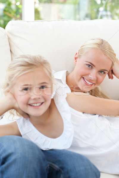 Beautiful woman lying down with her daughter at home Stock photo © wavebreak_media