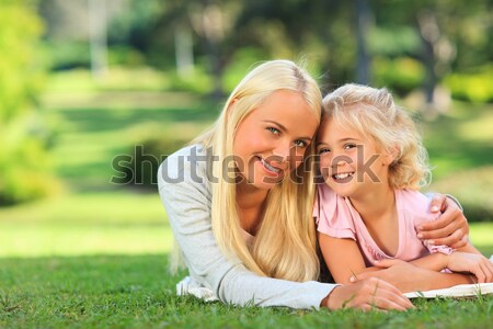 Mother with her daughter lying down in the park Stock photo © wavebreak_media