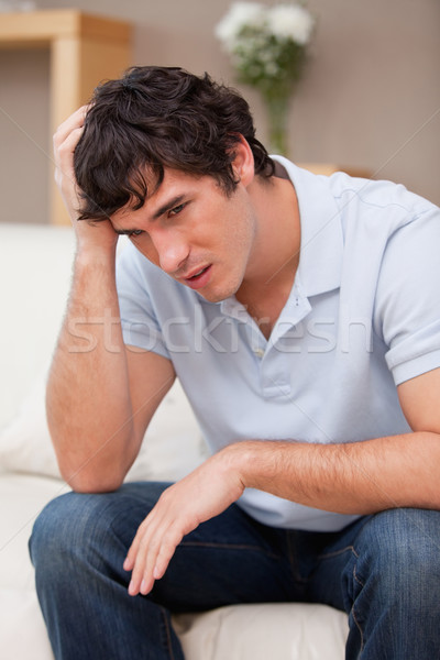 Despaired young man sitting on the sofa Stock photo © wavebreak_media