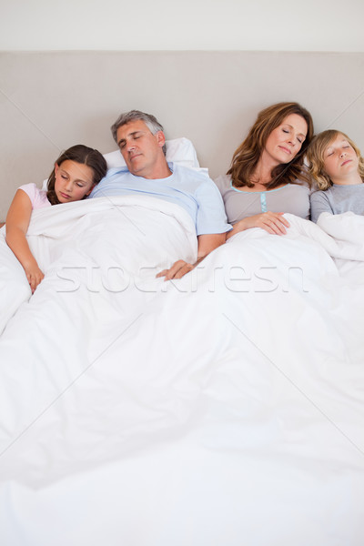 Stock photo: Family sleeping in the bedroom together