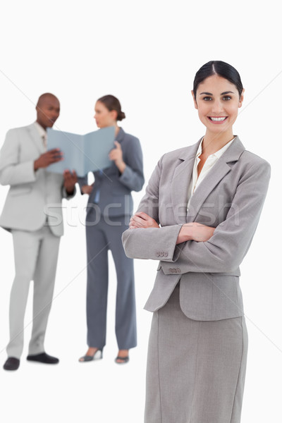 Smiling tradeswoman with crossed arms and team behind her against a white background Stock photo © wavebreak_media